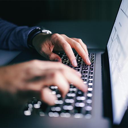 Hands typing on a keyboard