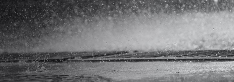 Rain hitting a puddle closeup