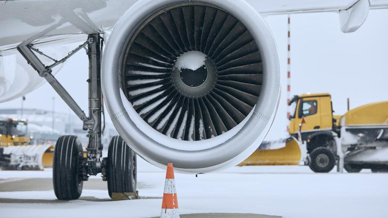 Airplane turbine close up on snowy runway